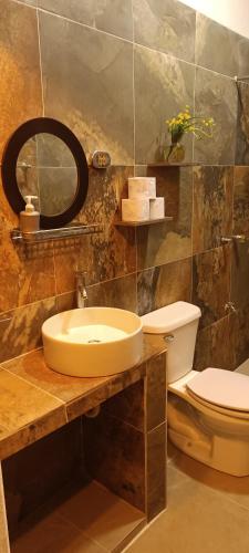 a bathroom with a sink and a toilet at casa flores in Bacalar
