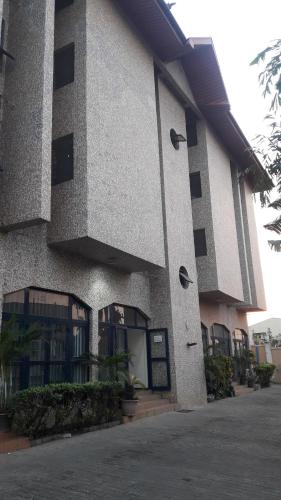 a building with windows and plants in front of it at Gifted Apartment & Residence in Abuja