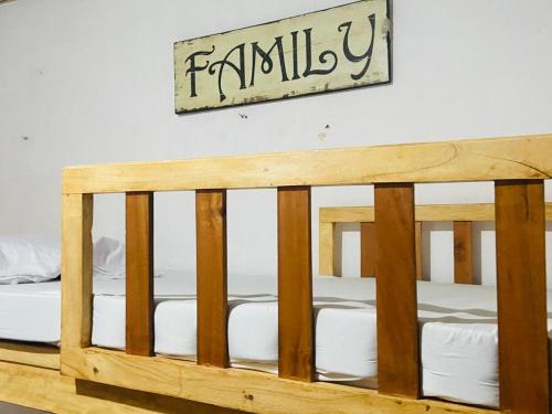 a wooden crib in a room with a sign on the wall at Old Bells Hostel in Santa Ana