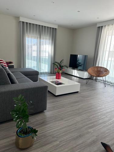 a living room with a couch and a table at Raphael Funchal Views Apartment in Funchal