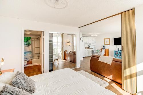 a bedroom with a bed and a living room at Fort Myers Beach Studio with Balcony and Views! in Fort Myers Beach