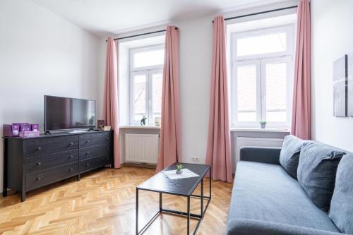 a living room with a couch and a tv at revLIVING Apartments Eggenburg in Eggenburg