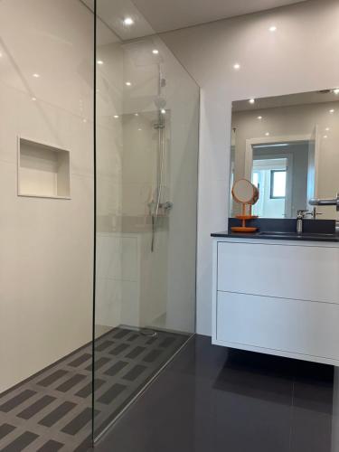 a bathroom with a glass shower and a sink at Raphael Funchal Views Apartment in Funchal