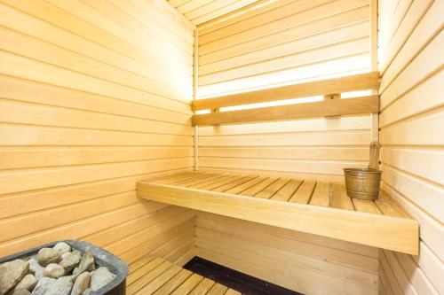 a small wooden sauna with a bucket in it at Exclusive House in Old Town in Tallinn