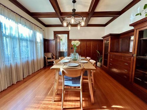 a dining room with a wooden table and chairs at *Boho Bungalow-King-Backyard-Full Kitchen-W/D* in Eureka