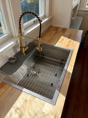 a kitchen sink with a faucet on a counter at *Boho Bungalow-King-Backyard-Full Kitchen-W/D* in Eureka