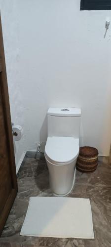 W pokoju znajduje się łazienka z białą toaletą. w obiekcie Hotel oBeja negra Muki w mieście Pitalito