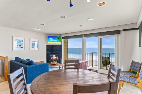 a living room with a table and a couch at A Wave From It All in Carlsbad