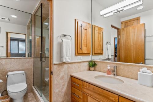a bathroom with a toilet sink and a shower at A Wave From It All in Carlsbad