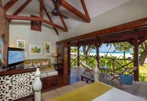 a living room with a view of the ocean at Paradise Sun Hotel Seychelles in Baie Sainte Anne