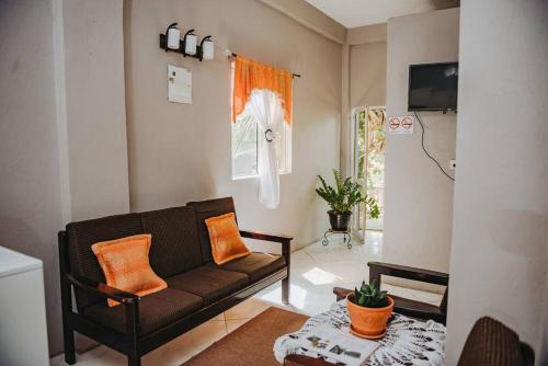 a living room with a couch and a table at The Local Experience-Zaboka Apartment in Choiseul