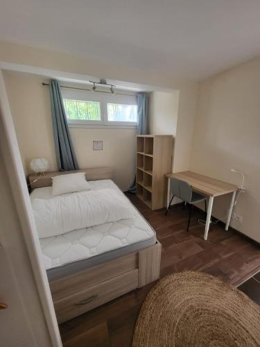 niewielka sypialnia z łóżkiem i biurkiem w obiekcie L'agréable w mieście Nantes