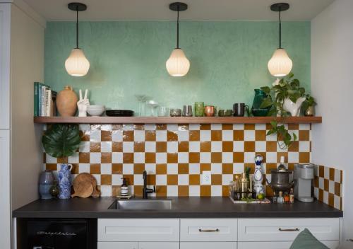 a kitchen with a checkered wall and a counter top at 2 Free Bikes, Pvt Parking, Steps to Beach! South Mission Beach in San Diego