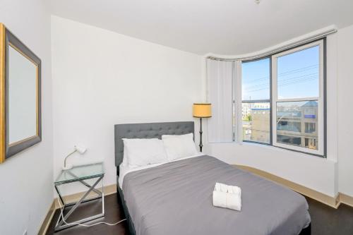 ein weißes Schlafzimmer mit einem Bett und einem Glastisch in der Unterkunft Marina Apartment Pool,Gym,Jacuzzi in Los Angeles
