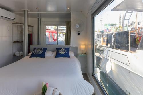 a bedroom with a bed and a large window at Unique in Barcelona ! Catamaran with a private swimming pool in Barcelona