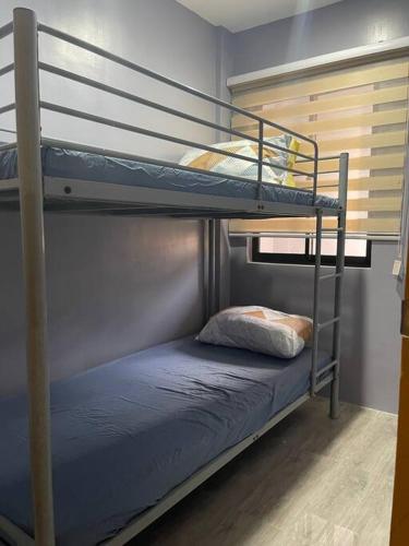 a bunk bed with a pillow on the bottom bunk at Cozy 2 storey fully furnished house. in Davao City