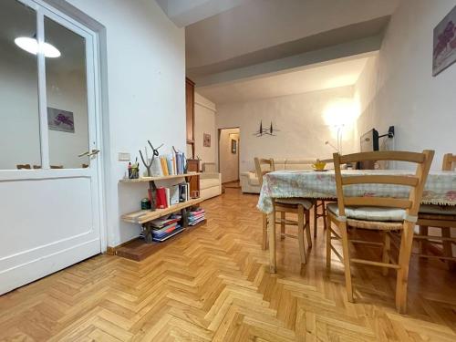 a room with a table and chairs and a living room at Appartamento Alessia (SMN) in Florence