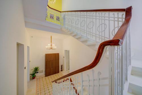 a staircase in a house with a chandelier at Casa Marie Unique Townhouse in Cospicua