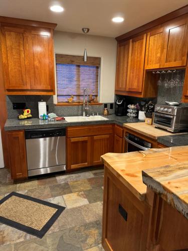 a kitchen with wooden cabinets and a stainless steel appliance at Lake Tahoe Luxury Guest Quarters in South Lake Tahoe