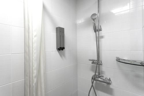 a bathroom with a shower with a shower curtain at Hotel Morning Sky in Seoul