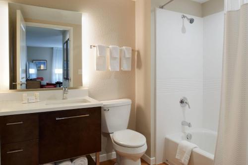 a bathroom with a toilet and a sink and a shower at TownePlace Suites by Marriott Richmond in Richmond