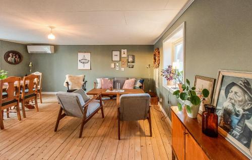 a living room with a dining table and chairs at Nice Home In Falkenberg With Wi-Fi in Falkenberg
