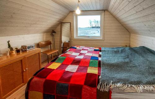 a bedroom with a colorful bed in a attic at Nice Home In Falkenberg With Wi-fi in Falkenberg