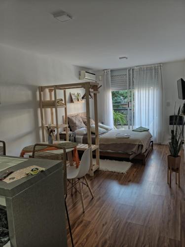 a bedroom with two bunk beds and a bed at Mono Ov Lagos in Rosario