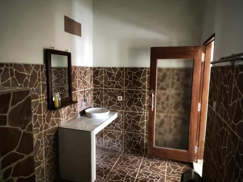 a bathroom with a sink and a mirror at Bias Bungalows in Gili Islands