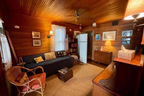 a living room with a couch and a refrigerator at Beach Retreat in Harbor Springs