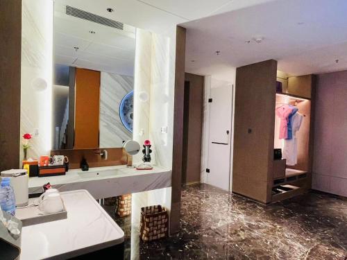 a large bathroom with a sink and a mirror at voco Xi'an Qindu Legend by IHG in Xi'an