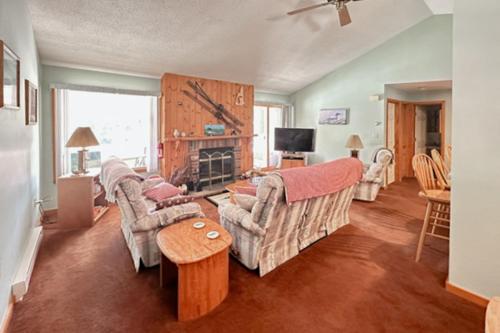 a living room with two couches and a fireplace at Relaxing on the River in Lincoln