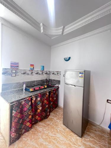 a kitchen with a stainless steel refrigerator in a room at Fresh studio in Dahab in Dahab