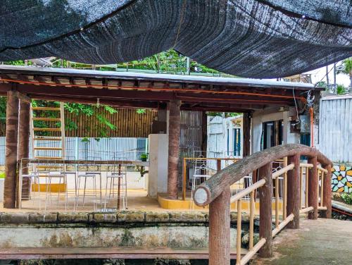 a pavilion with a table and chairs in a building at Czar's Place in Siquijor