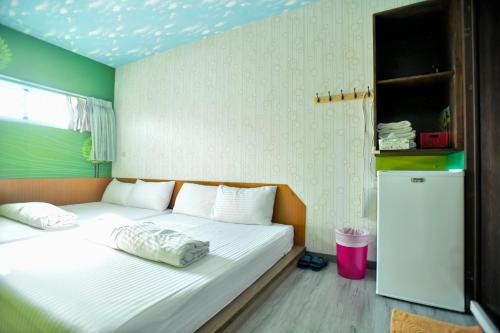 Postel nebo postele na pokoji v ubytování Ye Yuan Star Homestay