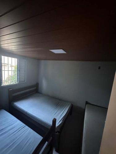 a small room with two beds and a window at Casa beiramar Provetá IlhaGrande in Angra dos Reis