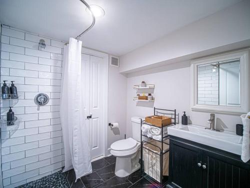 a white bathroom with a toilet and a sink at Rhythmic Escape in Marietta