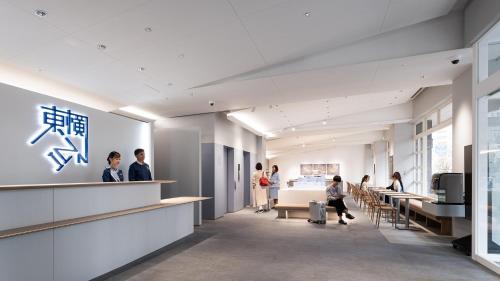 a rendering of the lobby of a building with people at Toyoko Inn Tokyo Haneda Airport No.2 in Tokyo