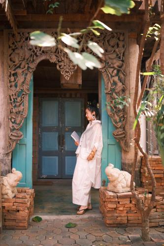 a man standing in the doorway of a building at BaanBooLoo Village in Chiang Mai