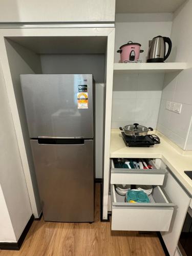 a kitchen with a stainless steel refrigerator in a kitchen at SA Sutera Avenue Homestay Kota Kinabalu Area KK City Opposite Imago in Kota Kinabalu