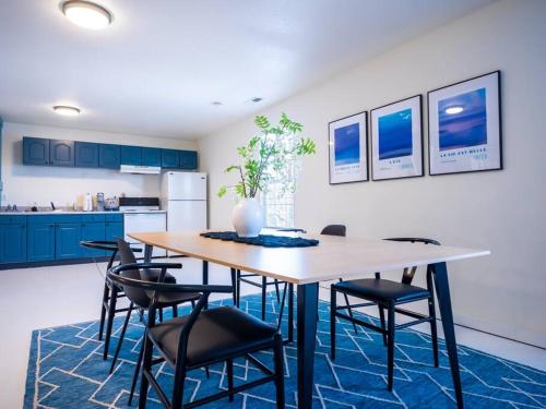 a kitchen with a table with chairs and a refrigerator at [L] House of Blues minutes KU/Mass & Shopping in Lawrence