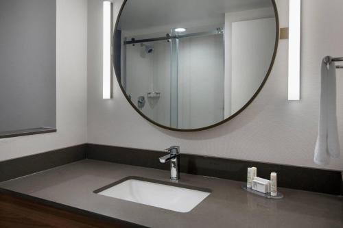 a bathroom with a sink and a large mirror at Fairfield Inn & Suites by Marriott Williamstown in Williamstown