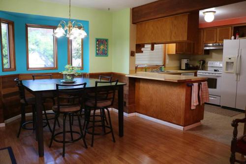 a kitchen with a table and some chairs in it at Whitaker 5 bdrm Daily-Weekly-Monthly in Eugene