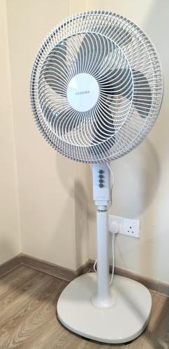 a white fan sitting on top of a floor at Kuching Prime Location Emporium - Nordict Retrett - 10 Pax in Kuching