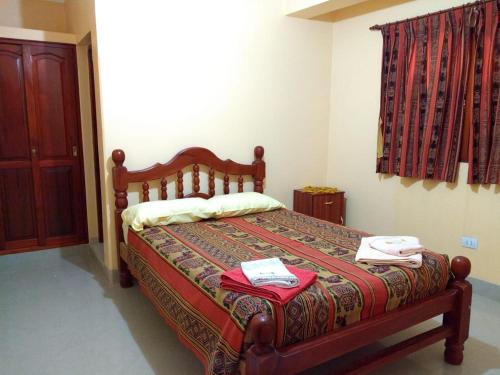 a bedroom with a bed with two towels on it at HOSTAL DOÑA BERTA in Humahuaca