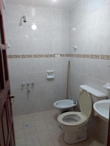 a bathroom with a toilet and a sink at HOSTAL DOÑA BERTA in Humahuaca