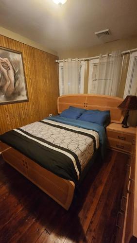 a bedroom with a large bed with blue pillows at 4 Bedroom Few Blocks From Beach , Tropicana Casino , Stockton University , Bay in Atlantic City