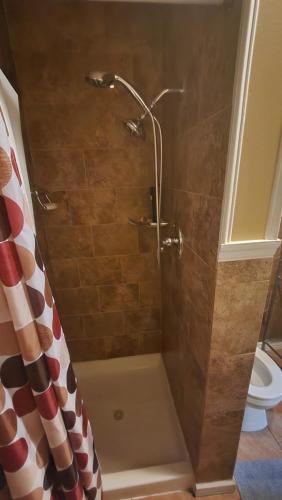 a shower with a shower curtain in a bathroom at 4 Bedroom Few Blocks From Beach , Tropicana Casino , Stockton University , Bay in Atlantic City