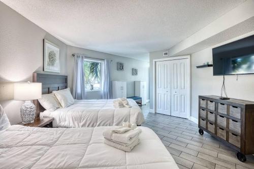 a hotel room with two beds and a tv at Oceanview Paradise at the Beach in Myrtle Beach