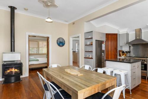 a kitchen and dining room with a wooden table and chairs at Marine Retreat - Geographe in Geographe